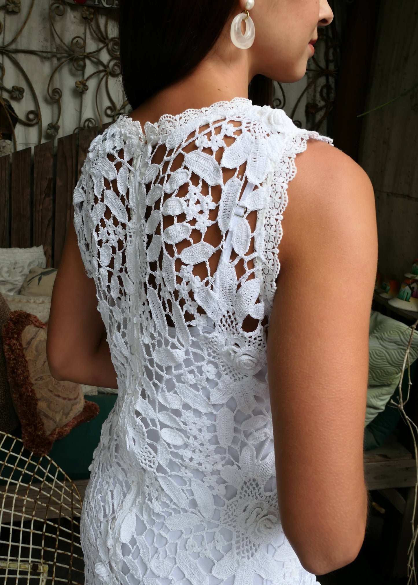 A sleek, feminine, no-frills sleeveless tank mini dress made with our Lim's classic floral and leaf themed hand crocheted fabric. Zips up the back. Wear as a coverup at the beach, or pair with a simple white slip dress for an elegant, boho chic feel.  Color: White