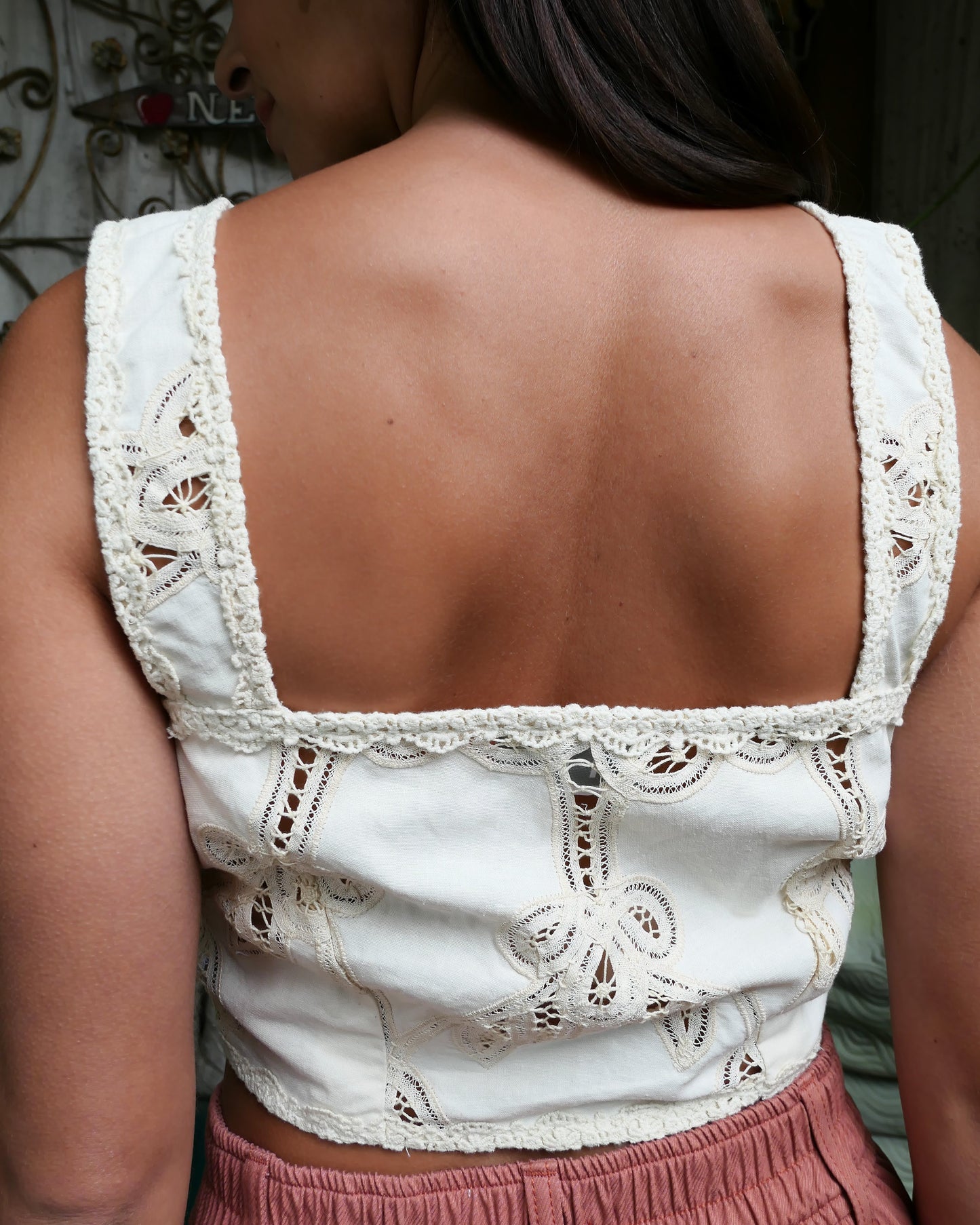 Closeup of back of bra top. Romantic vintage Battenberg lace meets Boho Chic in this ultra-cute bra top. Wear it alone with jeans, linen pants, or a skirt, or pair it with our Battenberg lace skirt (buy them as a set in our 2-piece set Collection). Has secure buttons and hooks in the front to ensure there are no noticeable gaps. Color: Natural