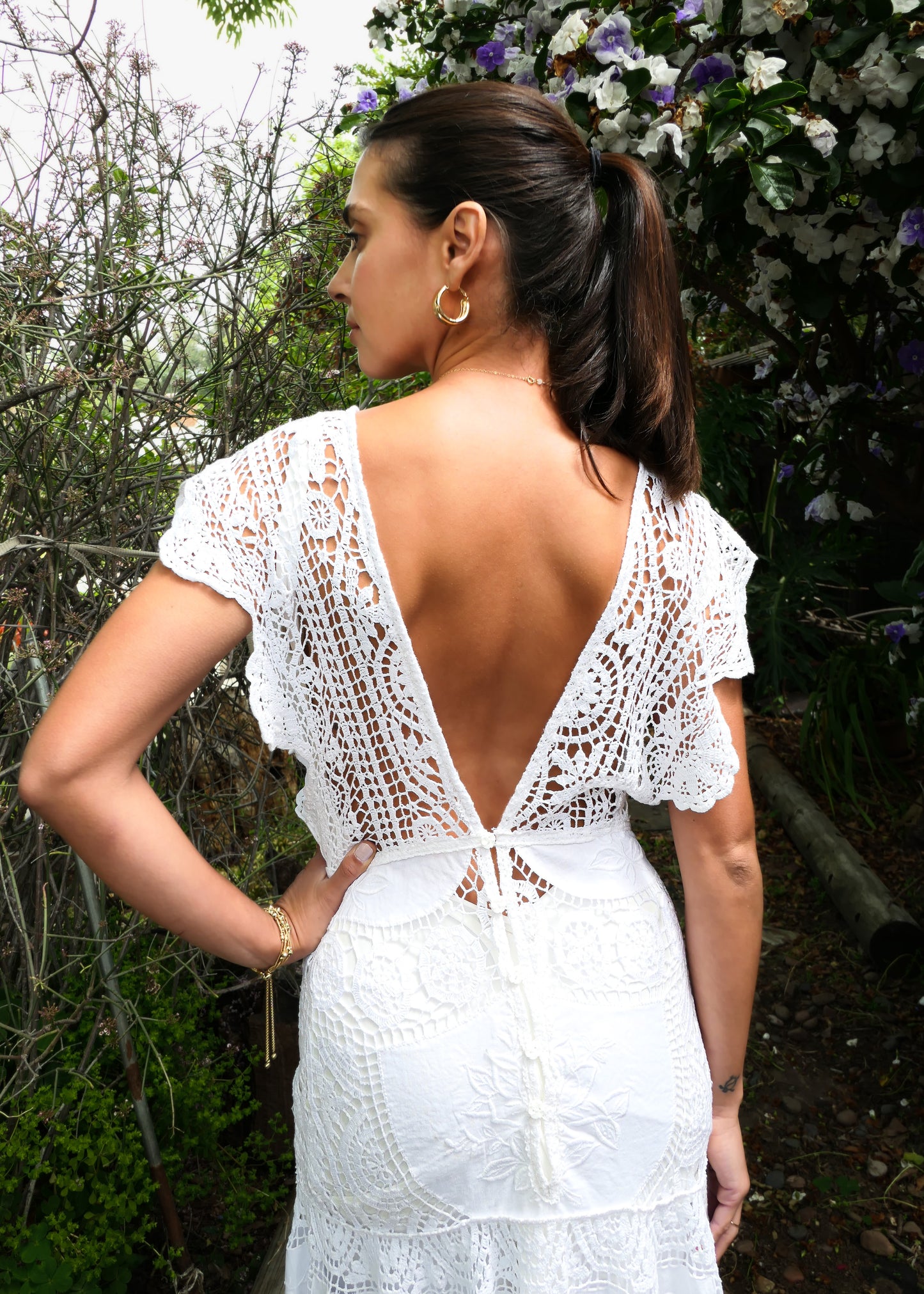 A romantic and elegantly seductive V-neck and V-back hand crocheted and embroidered patchwork maxi dress made with our signature Lim's Vintage fabric. This dress is fitted and flared at all the right places, accentuating your natural curves and perfect for your special wedding day or stylish summer beach party. Does not come with a slip, but we highly recommend wearing one due to the "holey" nature of the crochet.  Color: White. Can be made to order.
