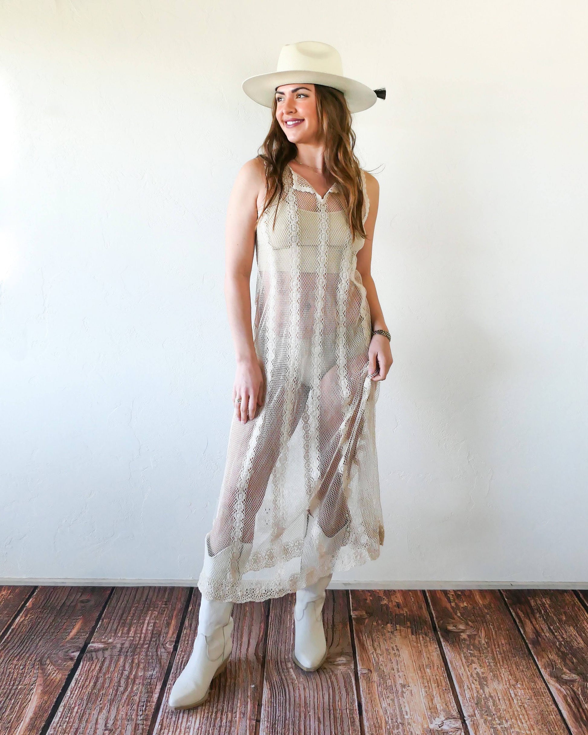 Dress worn with buttons in the front. A Lim's crochet fishnet tank maxi dress in Natural with vertical stripes composed of connected pinwheel-like circles. Versatile, lightweight, and an easy pullover dress that is reversible and can be worn with the buttons in the front or back. Perfect as a beach coverup, with boots and a cowgirl hat for that boho chic appeal or worn with a neutral slip and heels for a more sophisticated look. Size: Small to medium Measurements: Bust 32"- 36" Waist 46" Length 51" Hip 50"