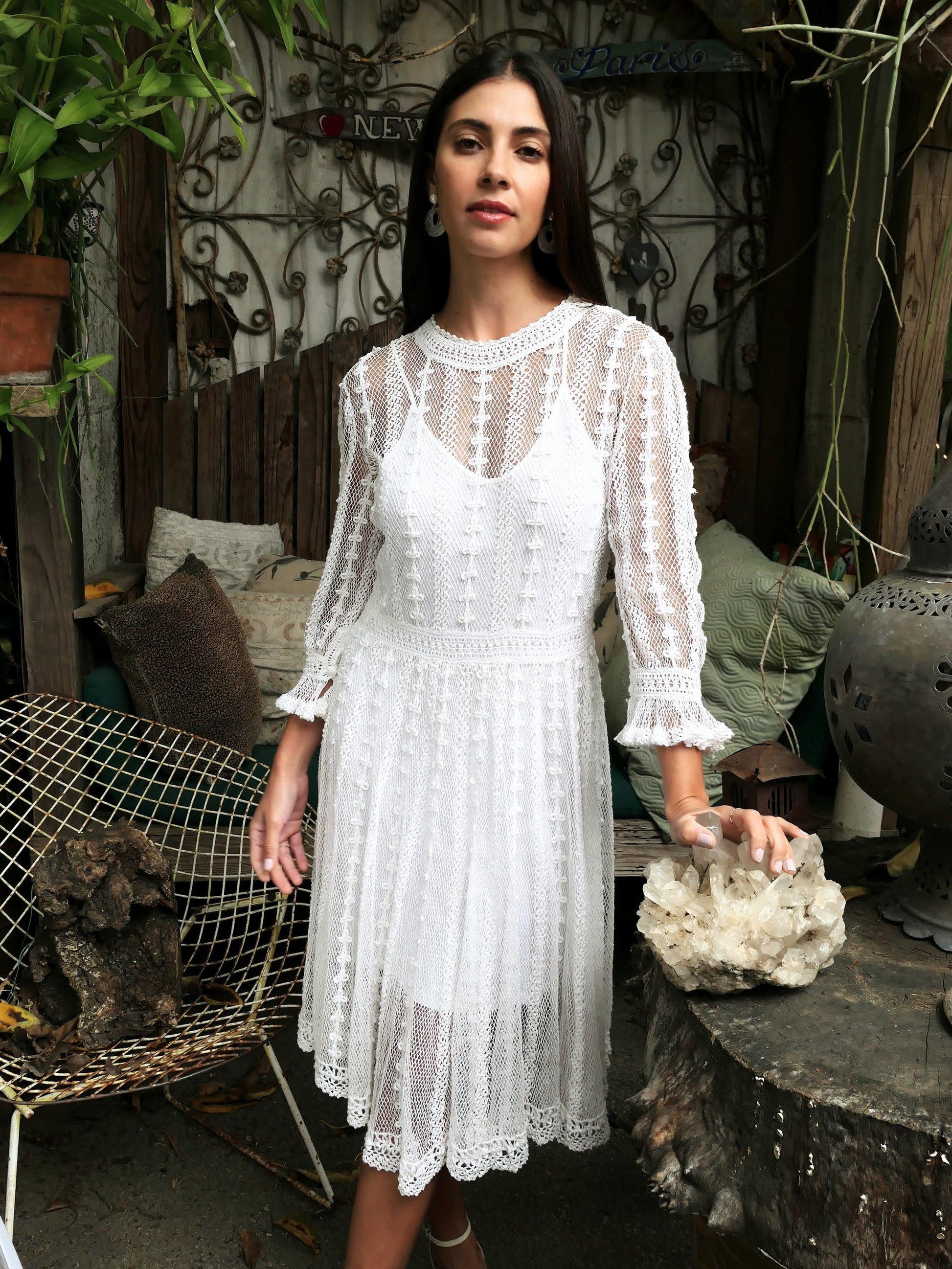 Lim's Vintage original crochet cottage core style dress. This dreamy midi length dress can be worn buttoned up the front or back and is made with very fine threads, making the dress refined and sheer. Detailed crochet trim is used for the waist, hemline, and 3/4 length ruffled sleeves. Wear it with a natural or pink colored slip or bandeau bra and bikini shorts and a pair of ankle or knee-high boots to complete the look.