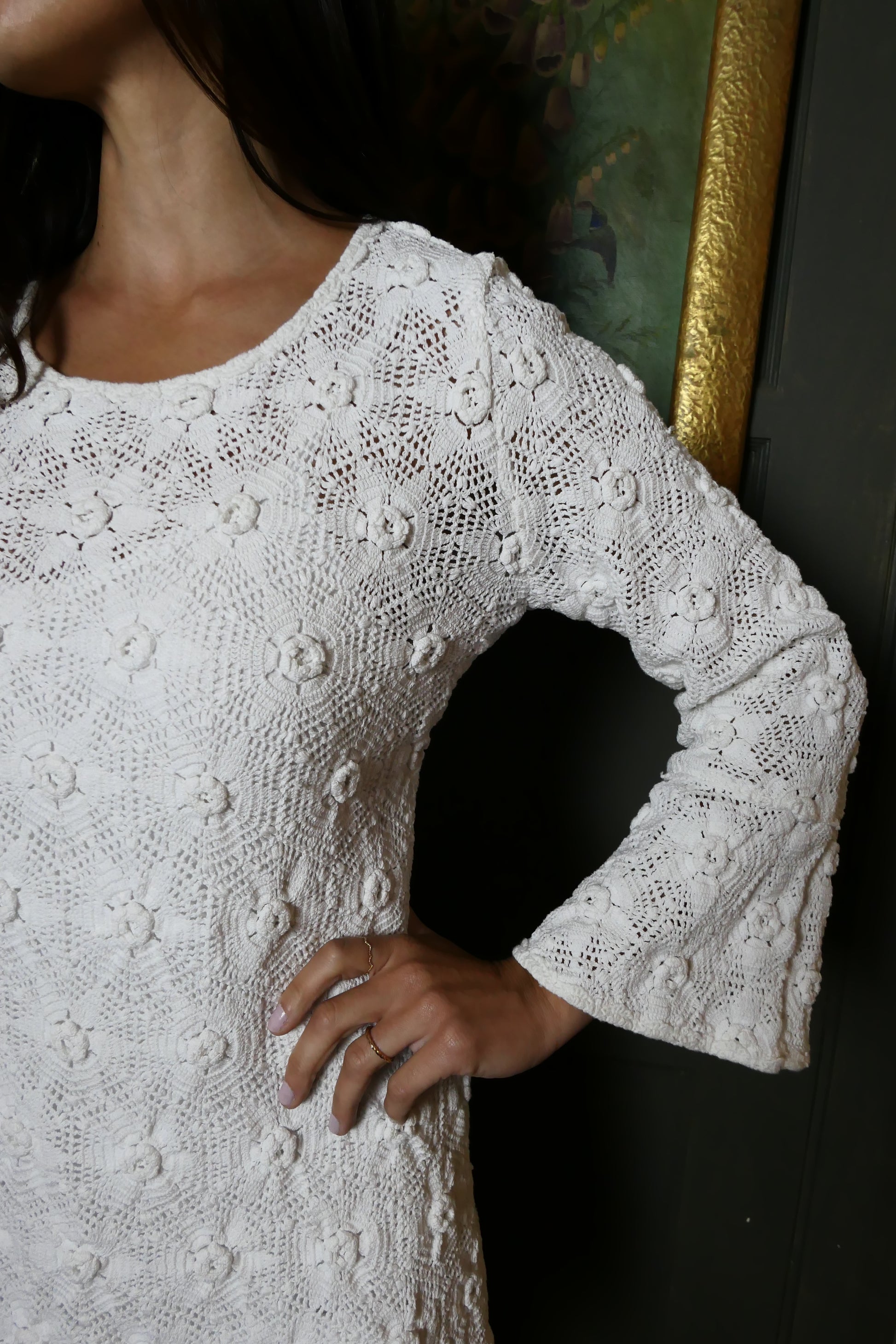 Close-up view of white crochet bell sleeve Lim's Vintage mini-dress. Color: White