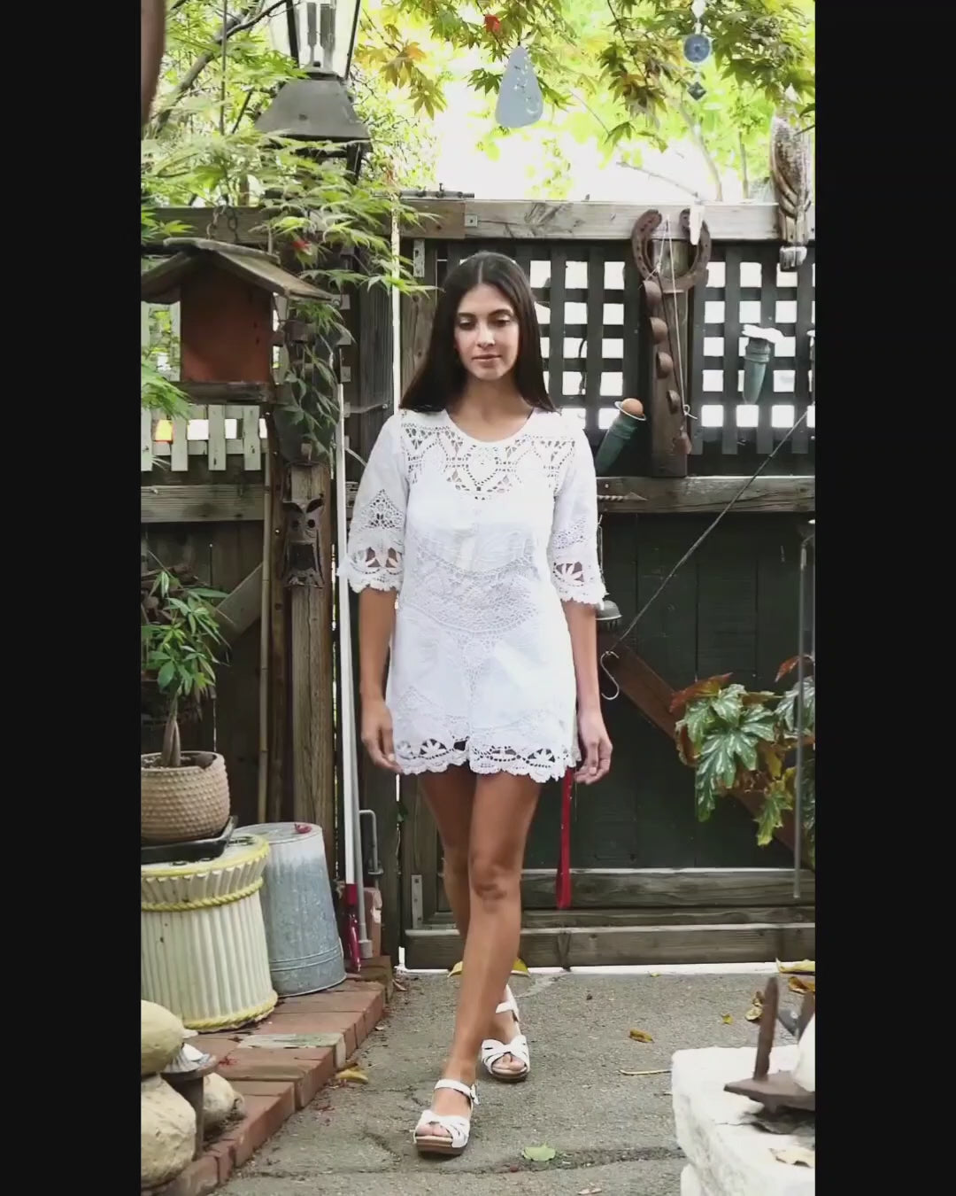 Video of model in white mixed crochet and patchwork embroidered tablecloth mini dress with 1/2 sleeves. By Lim's Vintage.