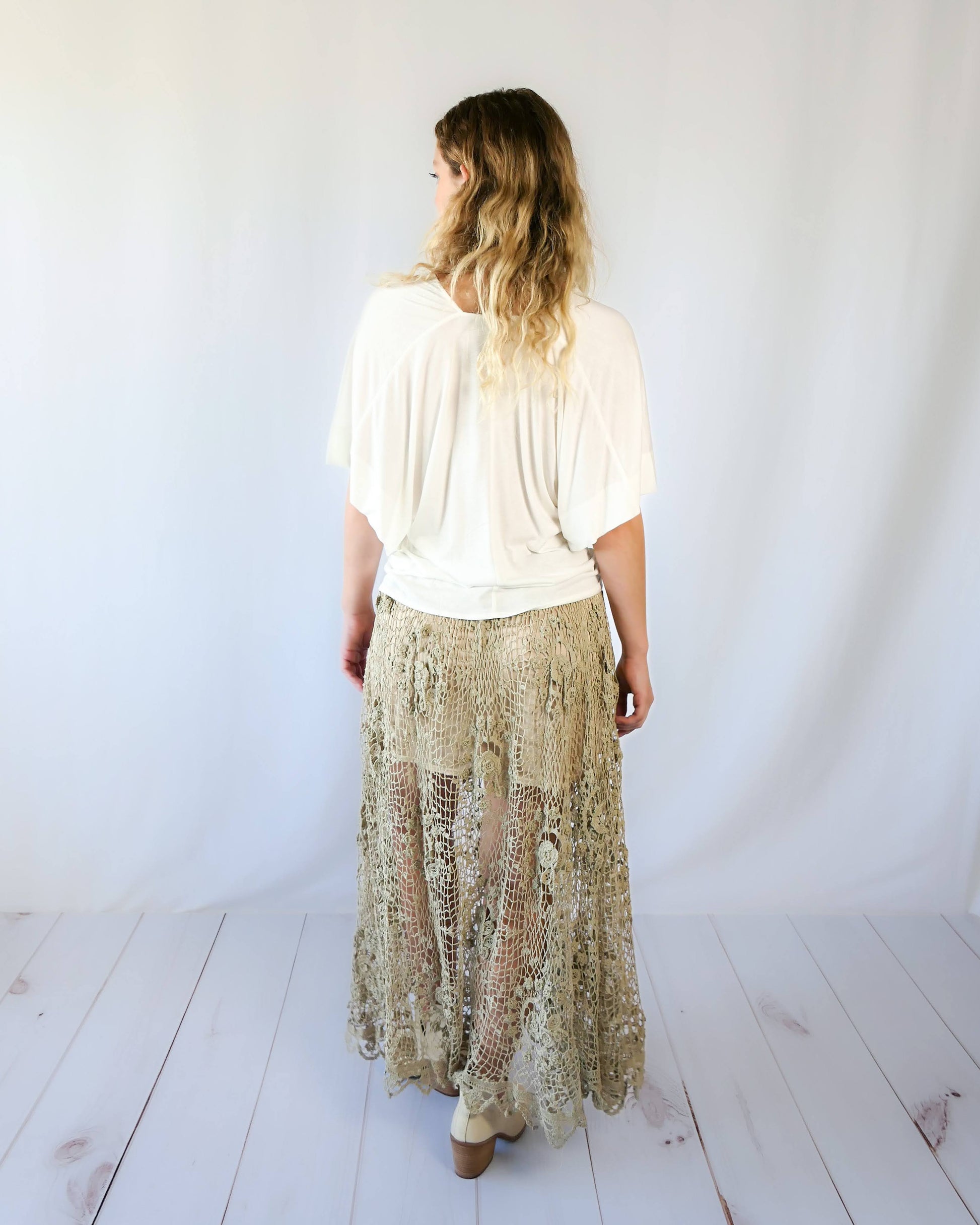 The ultimate cowgirl romantic hand crocheted maxi skirt with a circular floral design against a fishnet-like backdrop. This is an original Lim's piece from the 1980s and is truly a vintage collector's item!