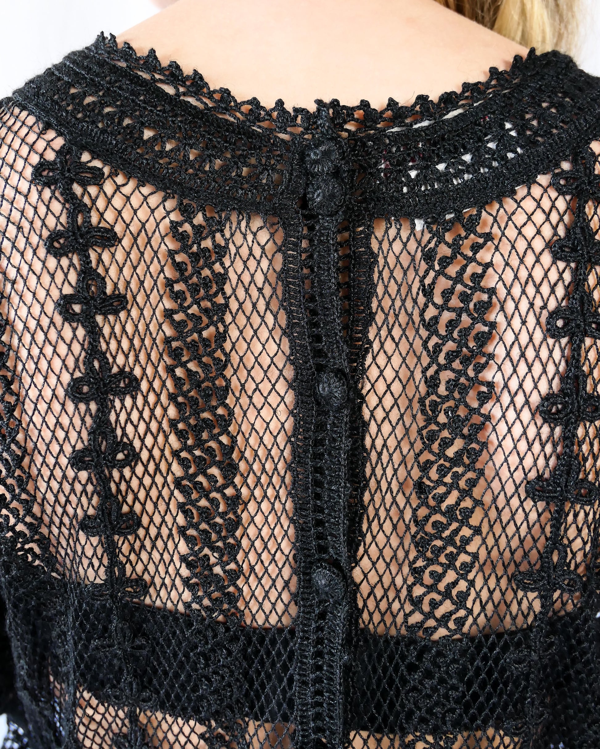 A beguiling black version of our cottage core style midi length crochet dress, this dreamy Lim's original vintage piece from the 1980s is made with very fine threads, creating a refined and sheer look. Detailed crochet trim is used at the waist, hemline, and 3/4 length ruffled sleeves. Measurements: Bust 36” Waist 30” Length 42” Shoulder width 15” Sleeve 20” Cuff circumference 9" Color: Black