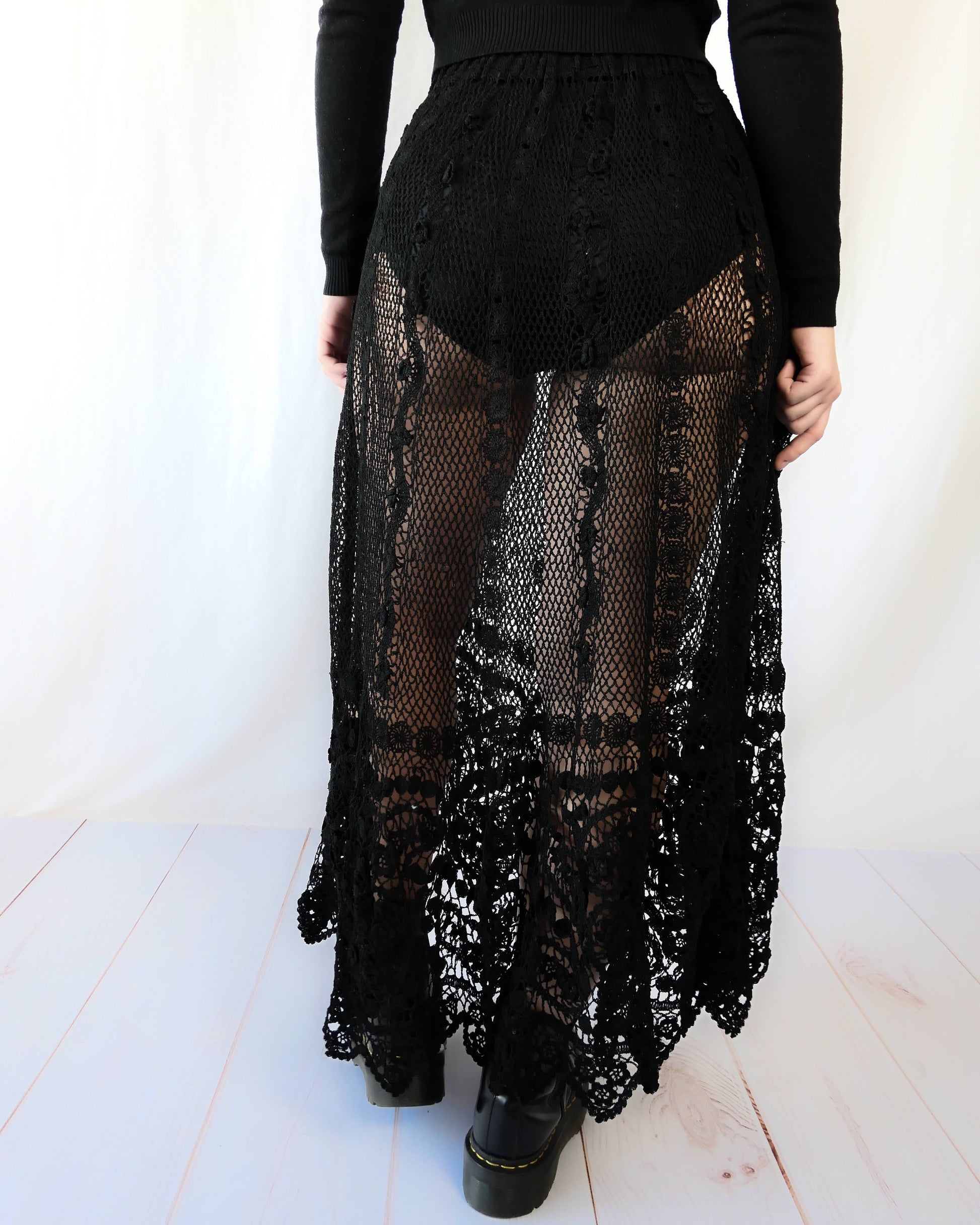Fall in love again with this original Lim's bohemian, whimsical black hand crocheted, maxi length skirt. Lovely paisley motif at the bottom hem, with vertical lines throughout the dress composed of intricate pinwheel-like circles and squiggly lines dotted with flowers. Looks stunning paired with a black silk camisole and bikini shorts, or a black sweater or crop top and a pair of boots.  Size: Fits Small to Medium﻿  Measurements:  Waist 26"- 30" Length 38" Hip 55” Color: Black  Material: 100% cotton