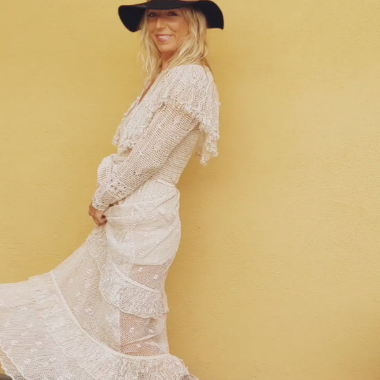 Video of model wearing Natural colored Lim's crochet maxi dress with ruffles and two-tiered ruffled hem.  