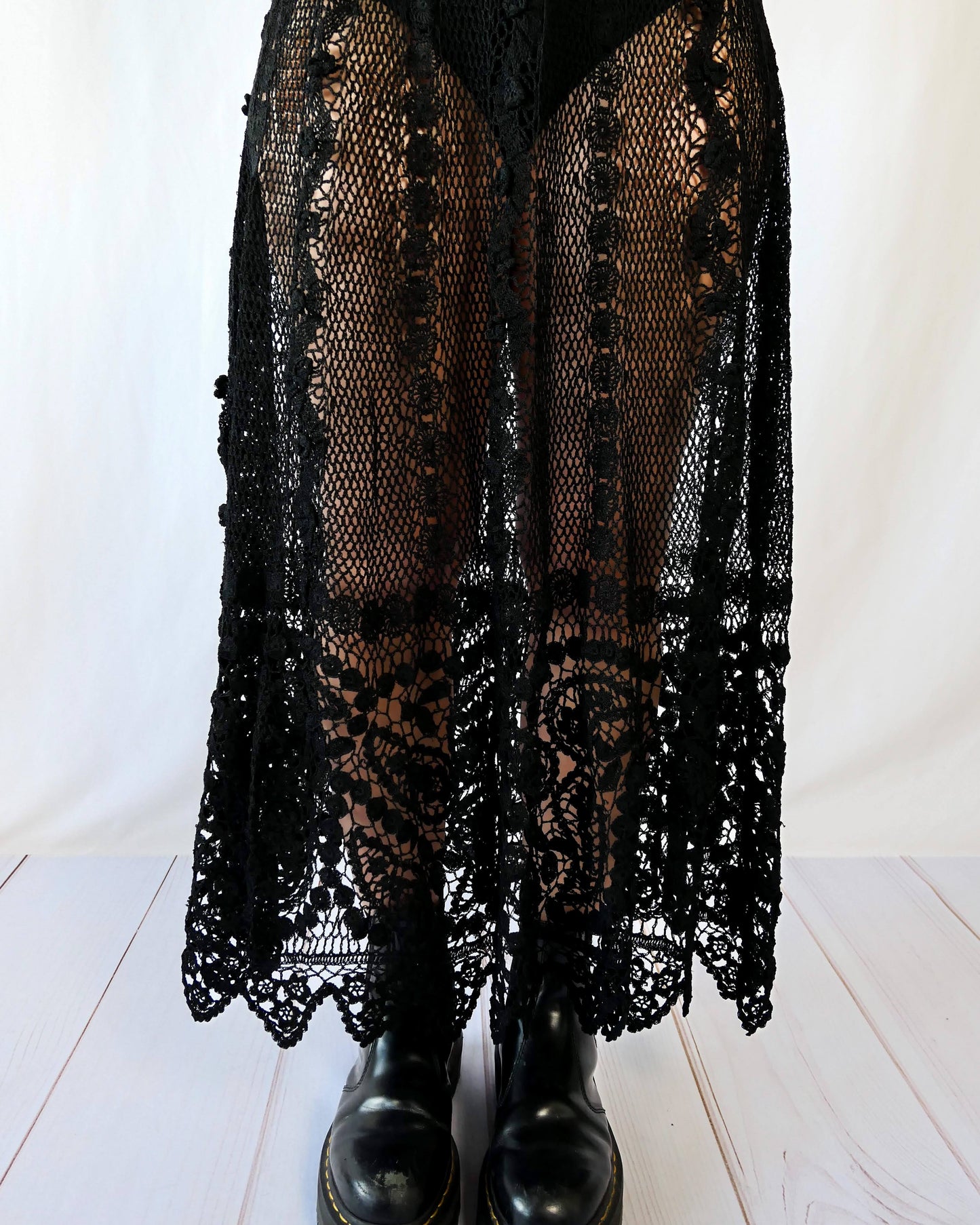 Fall in love again with this original Lim's bohemian, whimsical black hand crocheted, maxi length skirt. Lovely paisley motif at the bottom hem, with vertical lines throughout the dress composed of intricate pinwheel-like circles and squiggly lines dotted with flowers. Looks stunning paired with a black silk camisole and bikini shorts, or a black sweater or crop top and a pair of boots.  Size: Fits Small to Medium﻿  Measurements:  Waist 26"- 30" Length 38" Hip 55” Color: Black  Material: 100% cotton