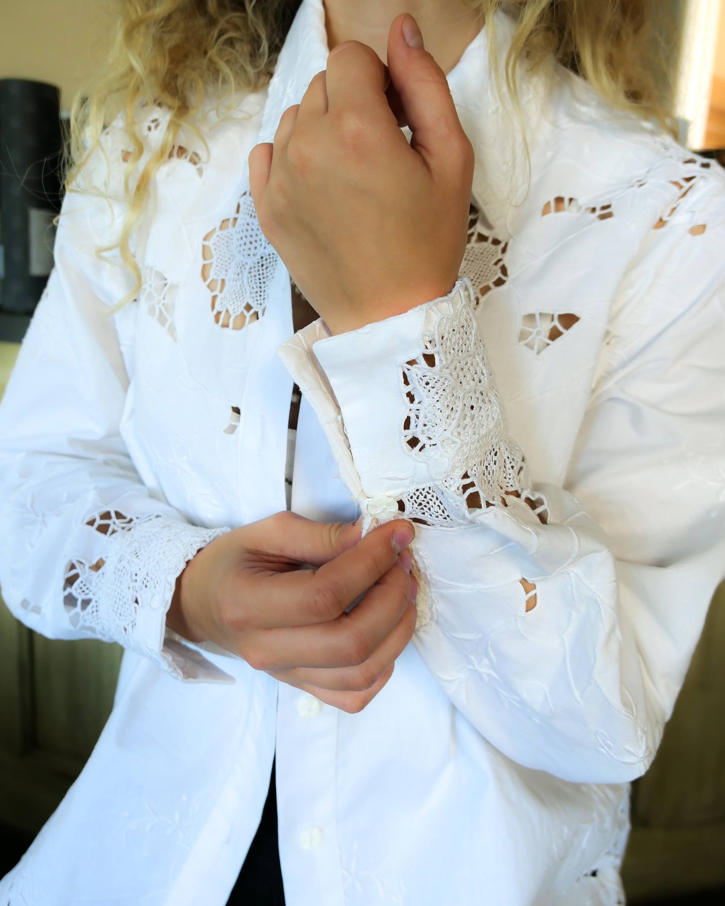 Uplift your everyday wardrobe with this cotton long sleeve shirt made with our vintage cutout and hand embroidered fabric. Embroidered and cutout detail in the collar, cuffs, and hemline make this shirt ultra-feminine and unique.  Note that the fabric is made with a thicker cotton fabric.  Comes in Small, Medium, and Large sizes.  