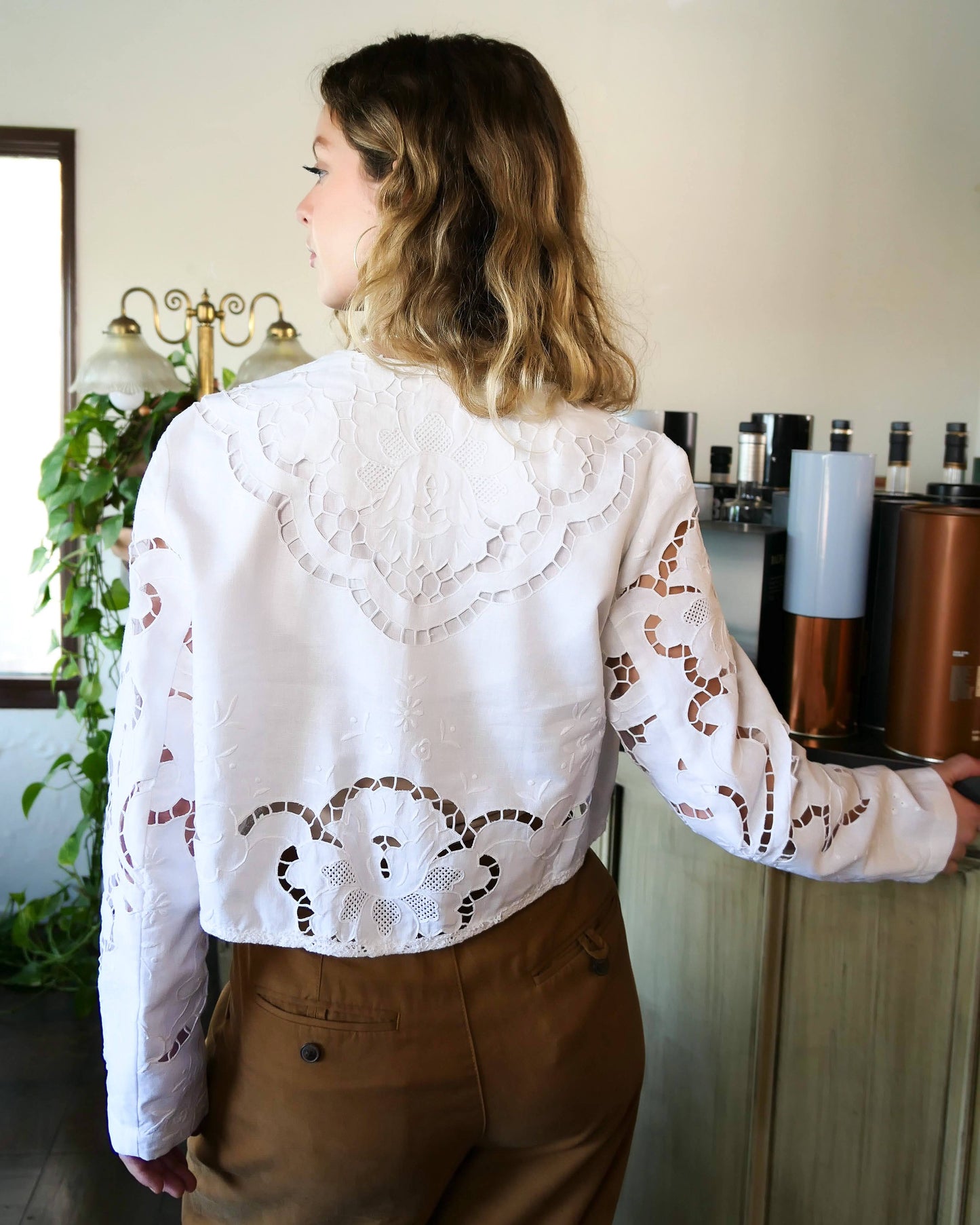 An elegant, lightweight crop bolero jacket made with intricate cutout and hand embroidered Lim's Vintage fabric. Pair it with your favorite wide leg pants and vintage leather boots.