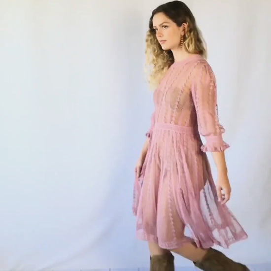 Video of model twirling around in midi length rose colored Lim's Vintage crochet dress.  