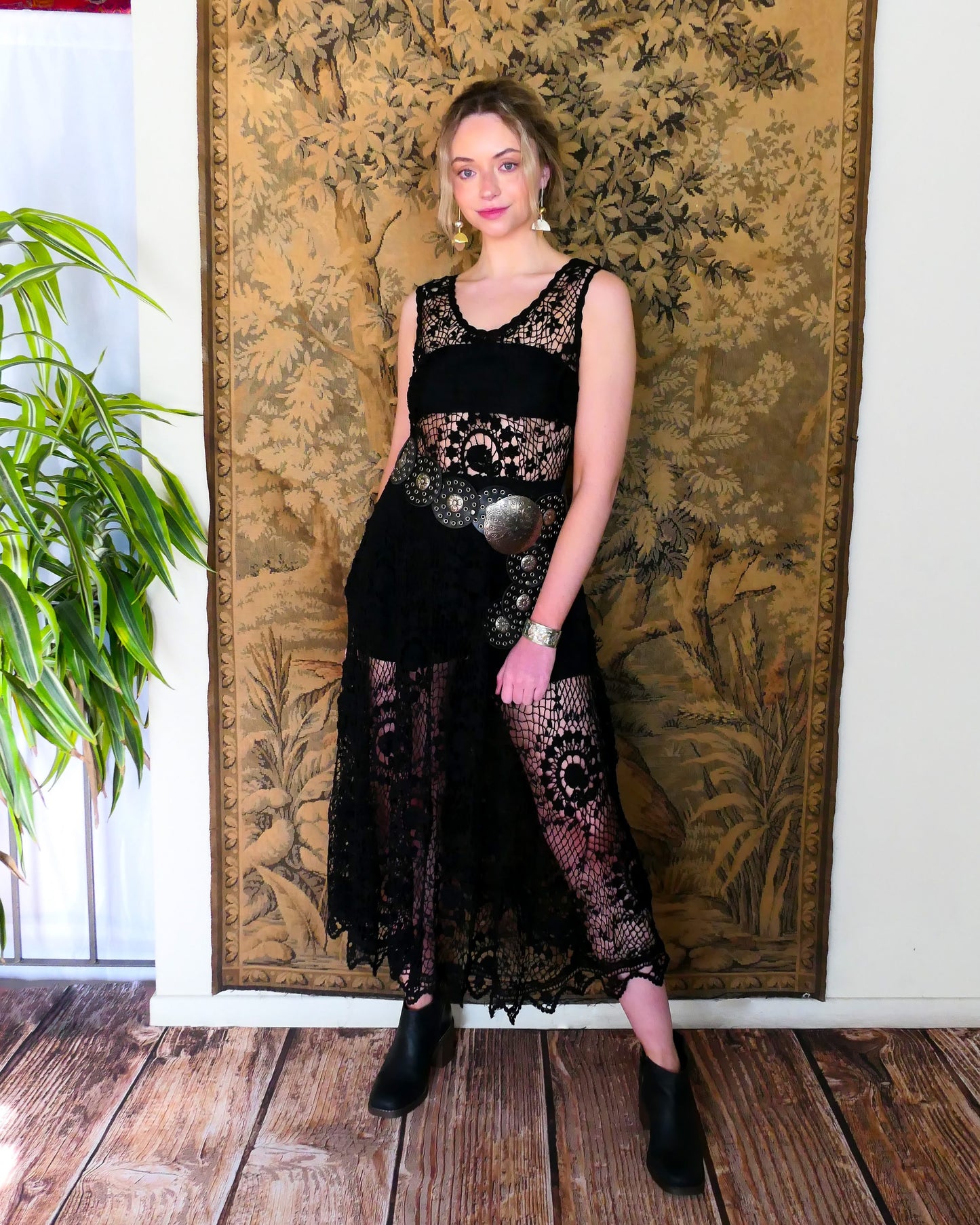 A black pullover tank maxi dress made with our Lim's Vintage crochet fabric.  Lovely repeating floral motif design against a fishnet background.  Elastic at the waist and looks great as a beach coverup or over a black slip, black strap sandals, and a pair of statement sunglasses. 