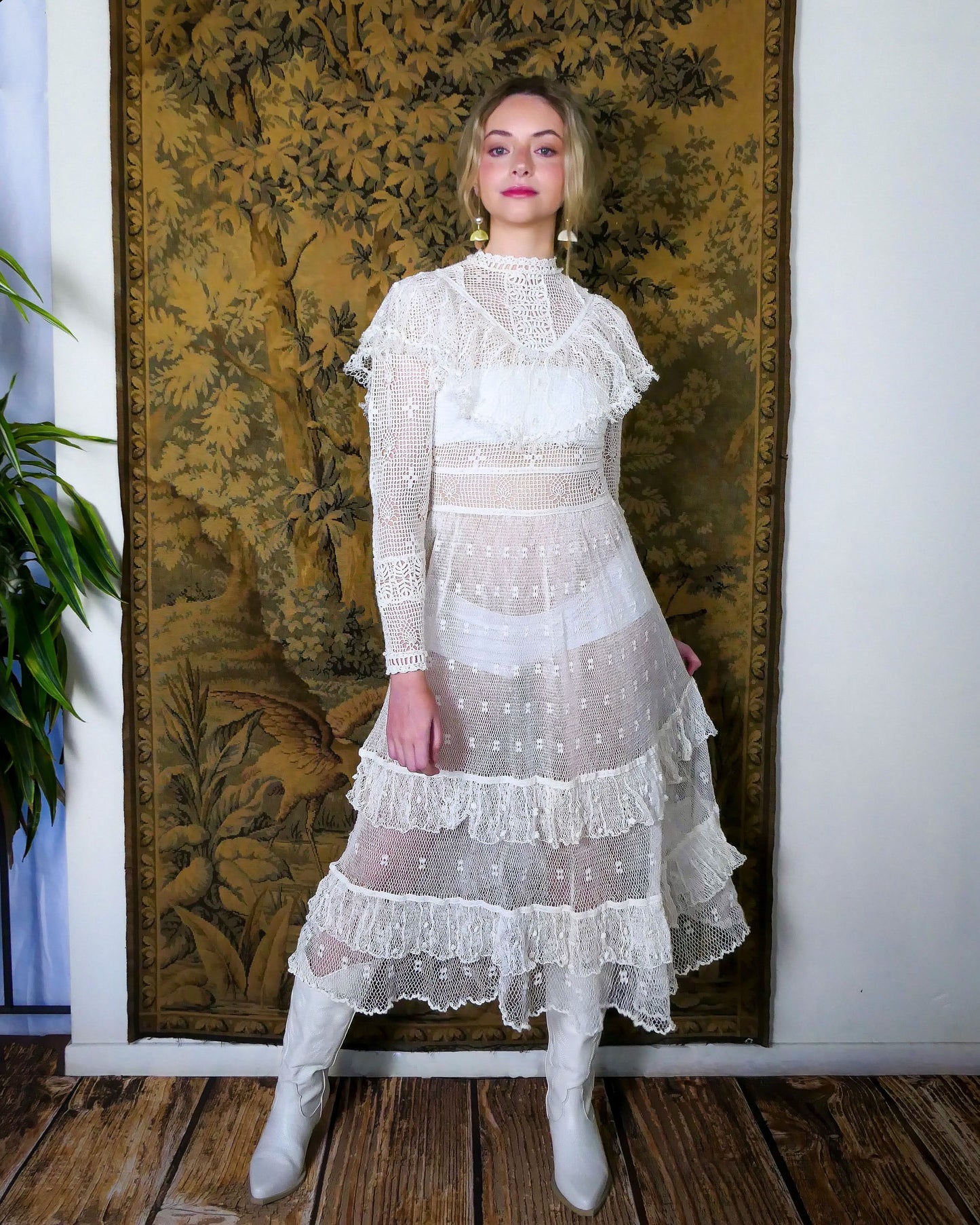 Model is wearing white Lim's crochet maxi dress with ruffles.  