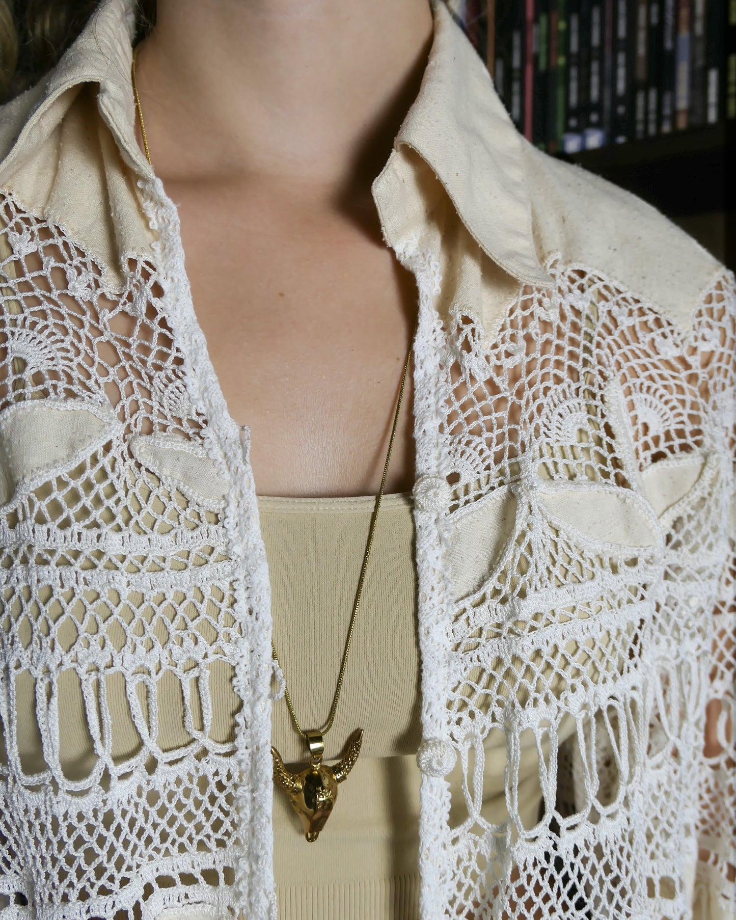 The perfect beach coverup top for your next getaway. An oversized hand crocheted button down top embellished with raw silk leaf-like cutouts. Looks great with a bralette and jeans, or a pair of white wide leg cotton pants, a straw hat, and flip flops.