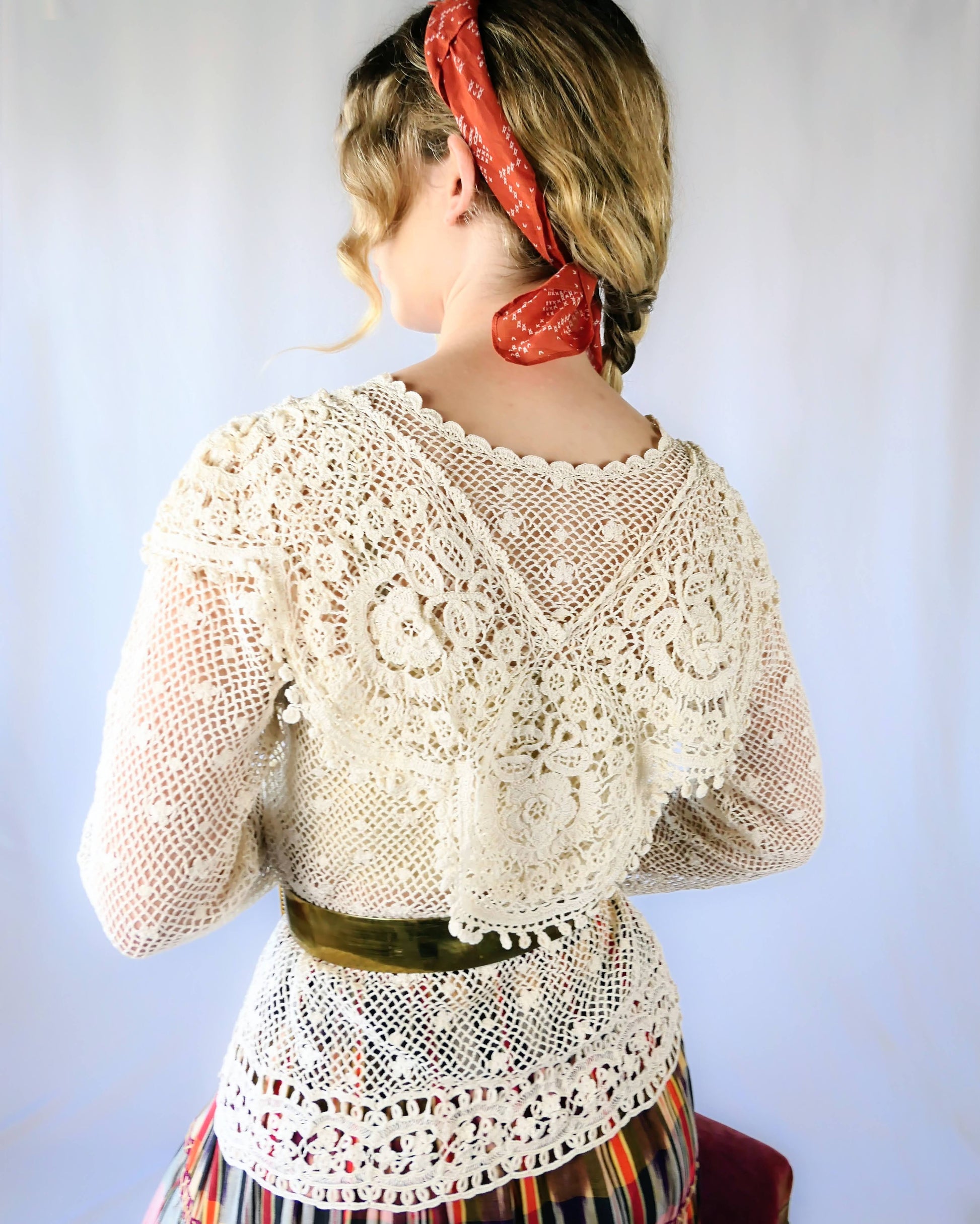 Back view of top. A cottagecore crew neck long sleeve top with intricate hand crocheted floral detail at the collar, hem, and sleeves. This timeless piece is an original Lim's top from the1980s and in excellent condition.  Natural color.