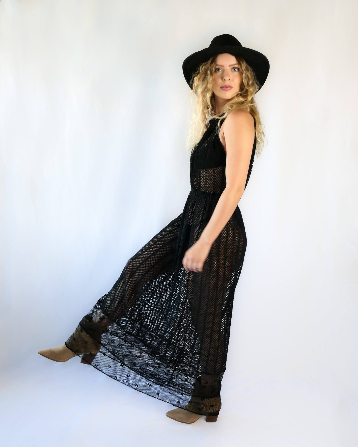 This boho chic dress in black is completely hand crocheted with soft cotton threads, with a Lim’s classic delicate net patterned crochet at the bottom hem.   The dress is worn with the button open at the front for a flattering V-neckline.  