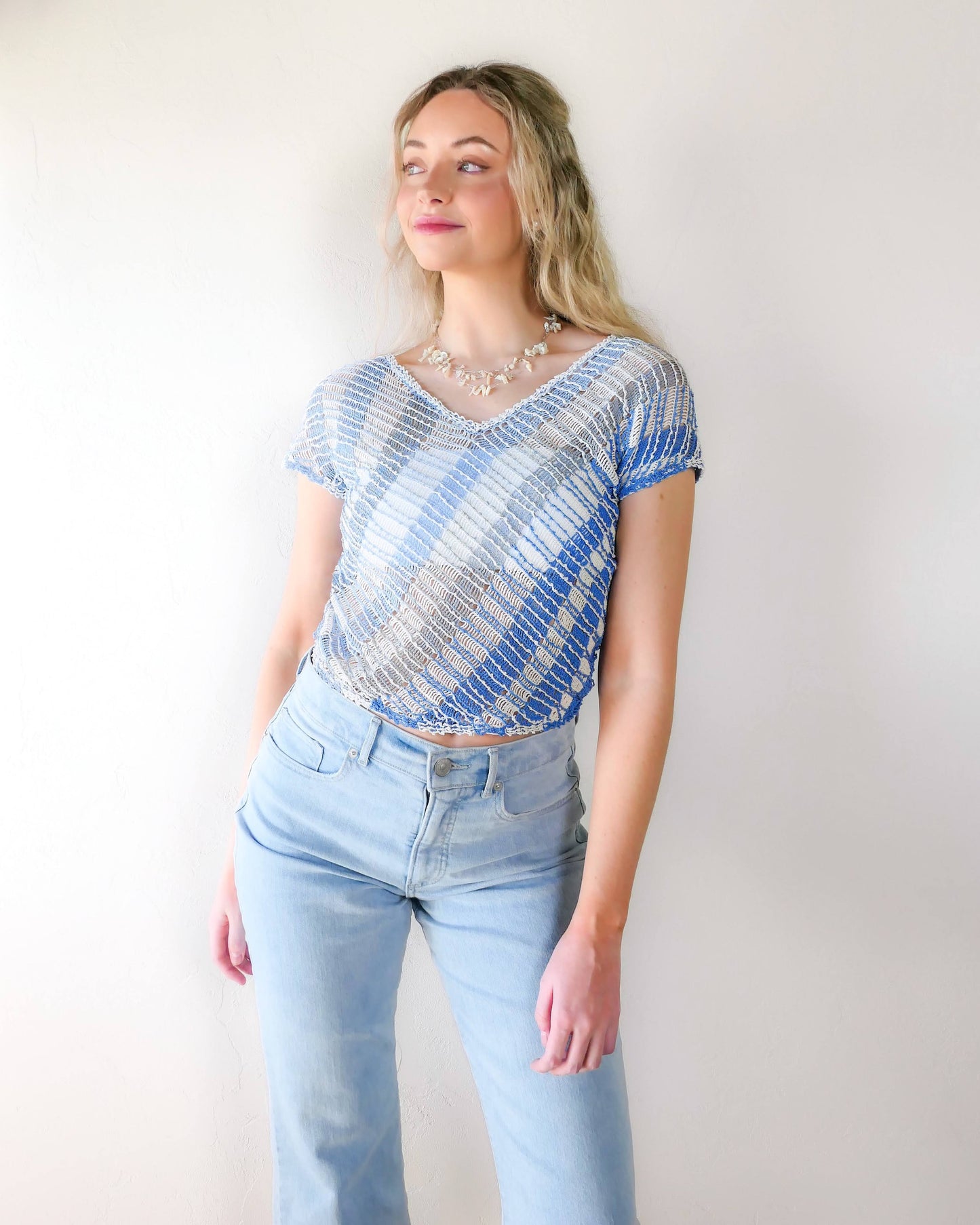 A short sleeve hand crocheted Lim's original 1980s pullover top with diagonal stripes in soft hues of blue and a flattering V-neck. A great color combo to lighten your mood during the spring and summer seasons! 