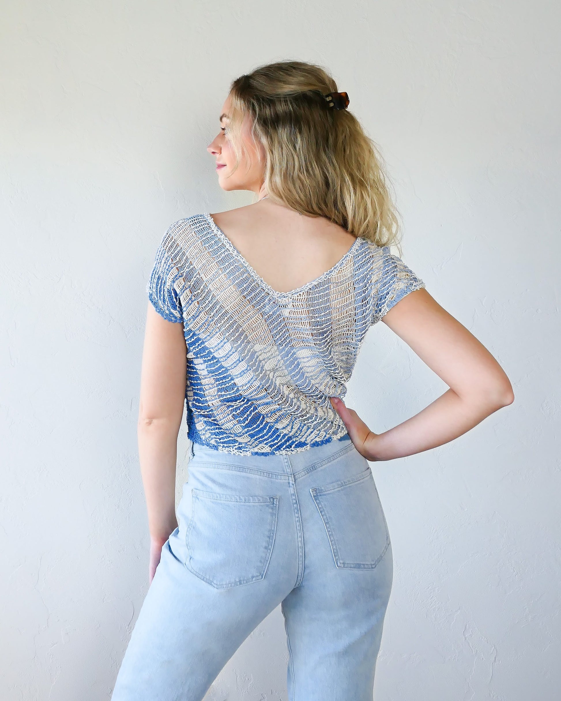 Back view with V-back. A short sleeve hand crocheted Lim's original 1980s pullover top with diagonal stripes in soft hues of blue and a flattering V-neck. A great color combo to lighten your mood during the spring and summer seasons! 