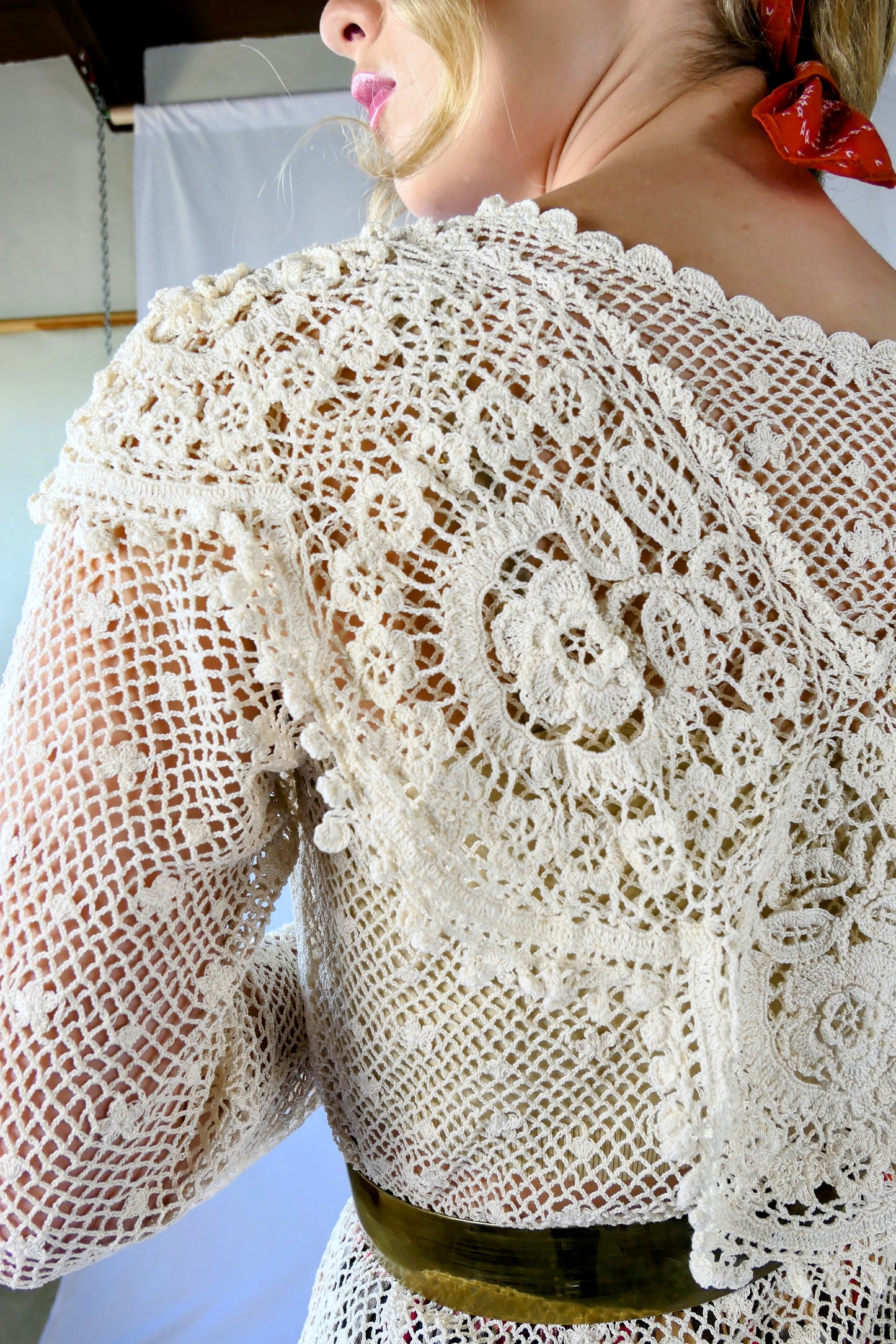 Closeup of top. A cottagecore crew neck long sleeve top with intricate hand crocheted floral detail at the collar, hem, and sleeves. This timeless piece is an original Lim's top from the1980s and in excellent condition.  Natural color.