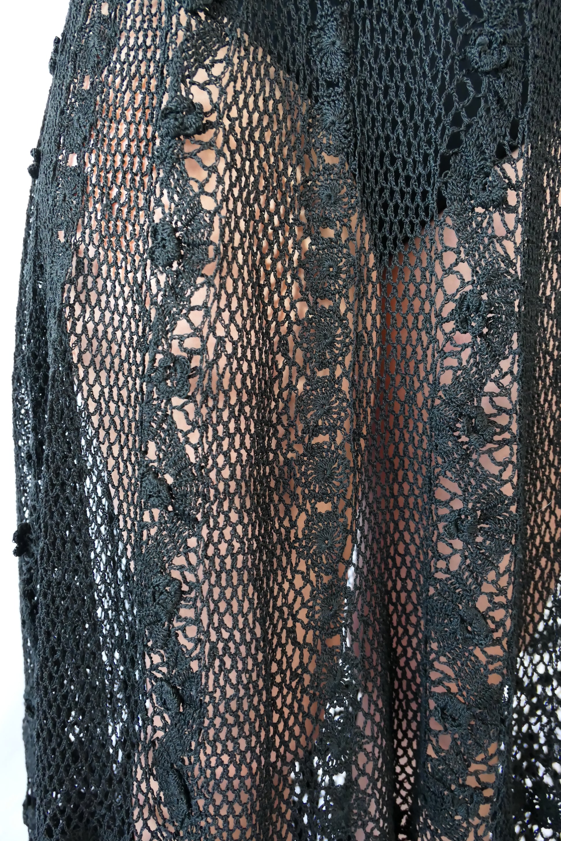 Fall in love again with this original Lim's bohemian, whimsical black hand crocheted, maxi length skirt. Lovely paisley motif at the bottom hem, with vertical lines throughout the dress composed of intricate pinwheel-like circles and squiggly lines dotted with flowers. Looks stunning paired with a black silk camisole and bikini shorts, or a black sweater or crop top and a pair of boots.  Size: Fits Small to Medium﻿  Measurements:  Waist 26"- 30" Length 38" Hip 55” Color: Black  Material: 100% cotton