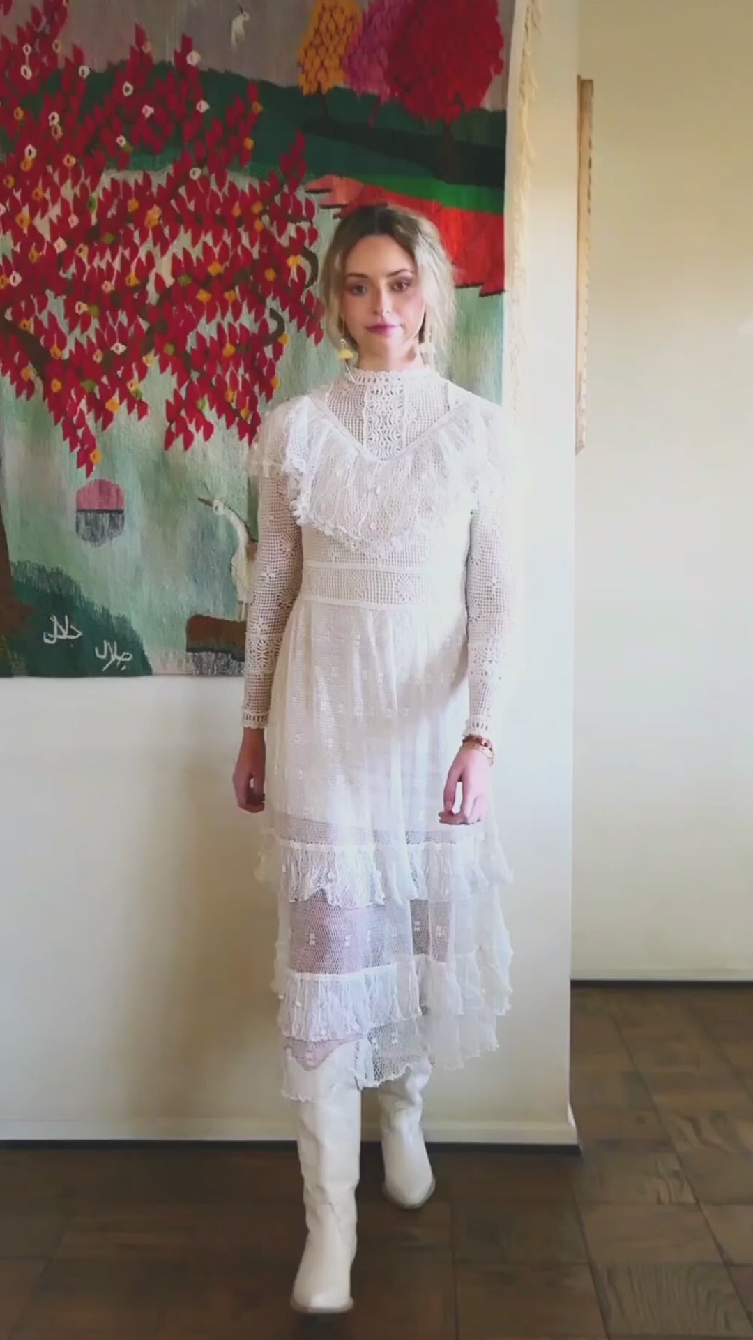 Video of model wearing Lim's white vintage crochet maxi dress with ruffles at the collar and two tiered hem.  