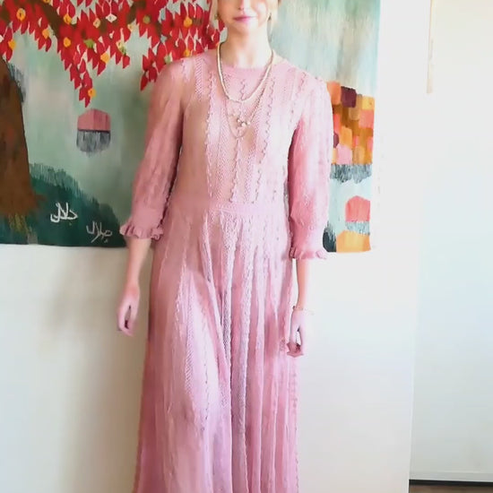 Video of model walking down the hallway wearing Lim's crochet maxi dress in rose color.  