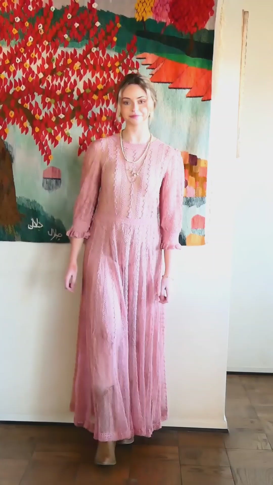 Video of model walking down the hallway wearing Lim's crochet maxi dress in rose color.  