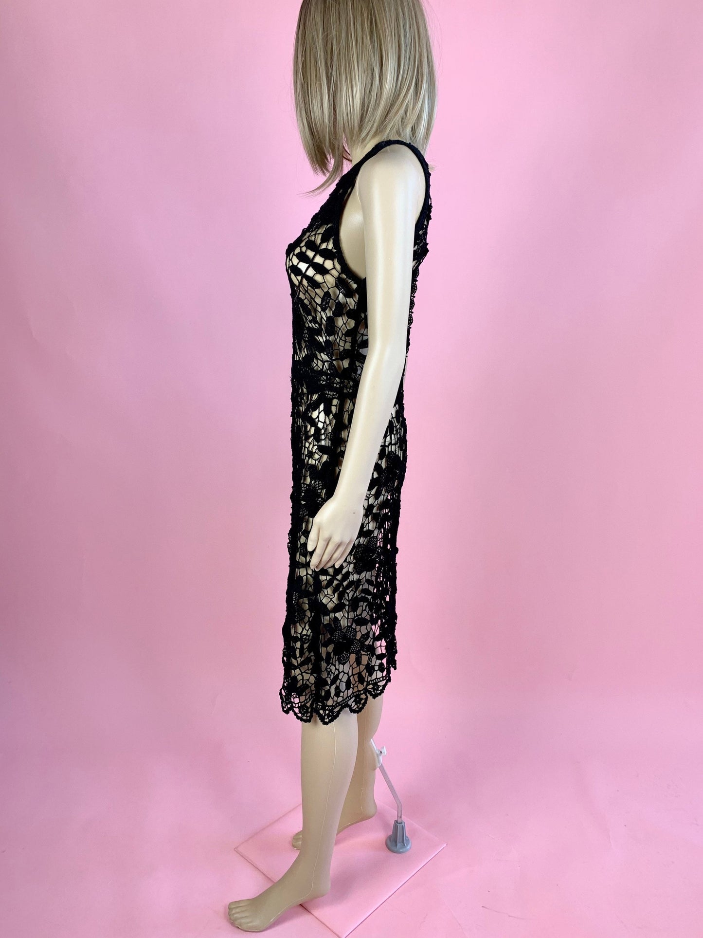 Lim's Vintage black crochet sleeveless halter midi dress with leaf and floral motif and zig-zag hem.  The top is reversible and can be worn with buttons going down the front or back.  Elastic waistband connects the top and bottom of the dress.  