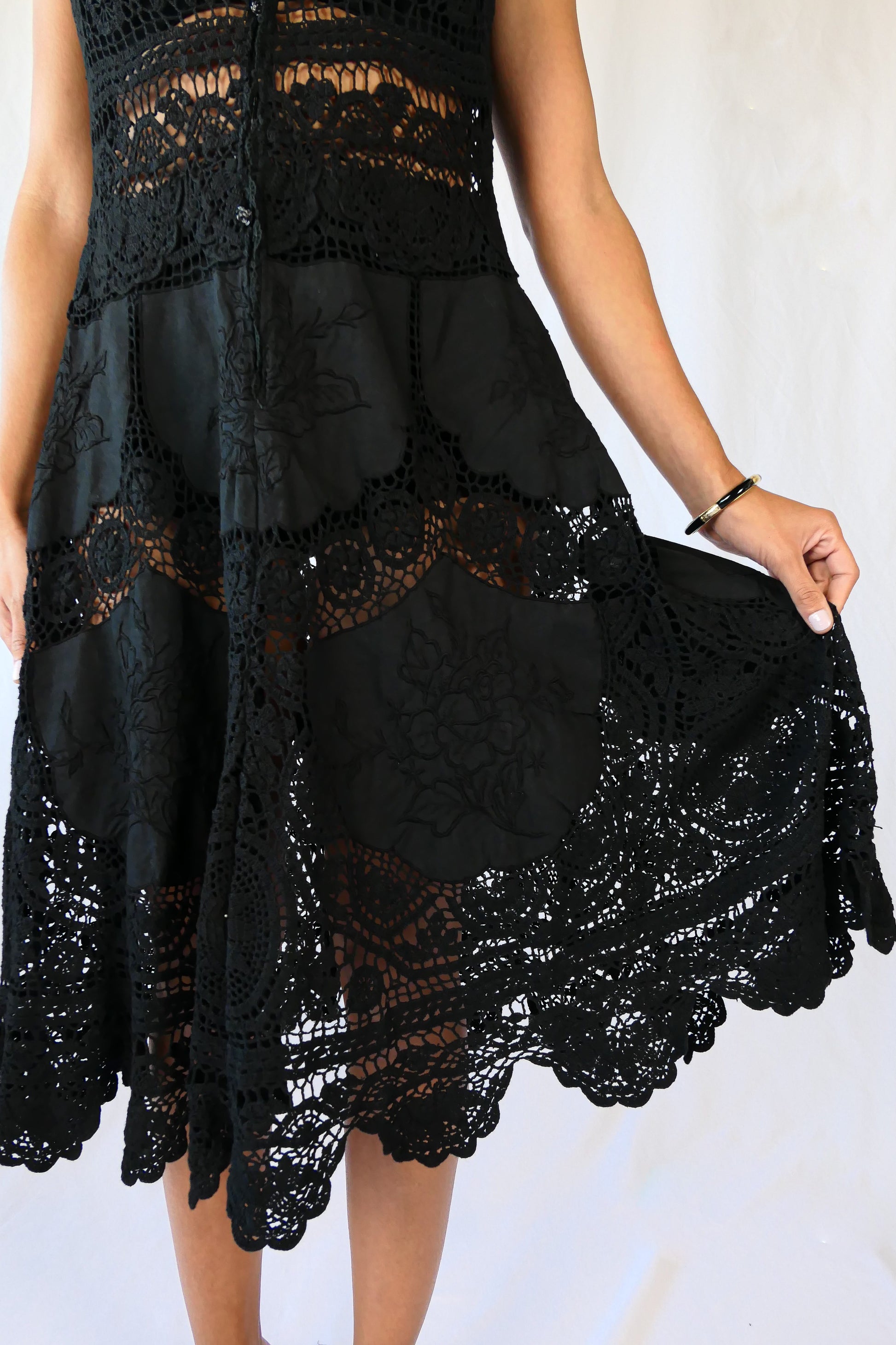 This Little Black Dress with detailed hand crochet and embroidery work lends itself a vintage flair.  The dress can be buttoned up the front or back, has a flattering fit at the waist, and flares out towards the hem.  Wear it as a cocktail dress with black heels or sandals, or as a beach coverup.  
