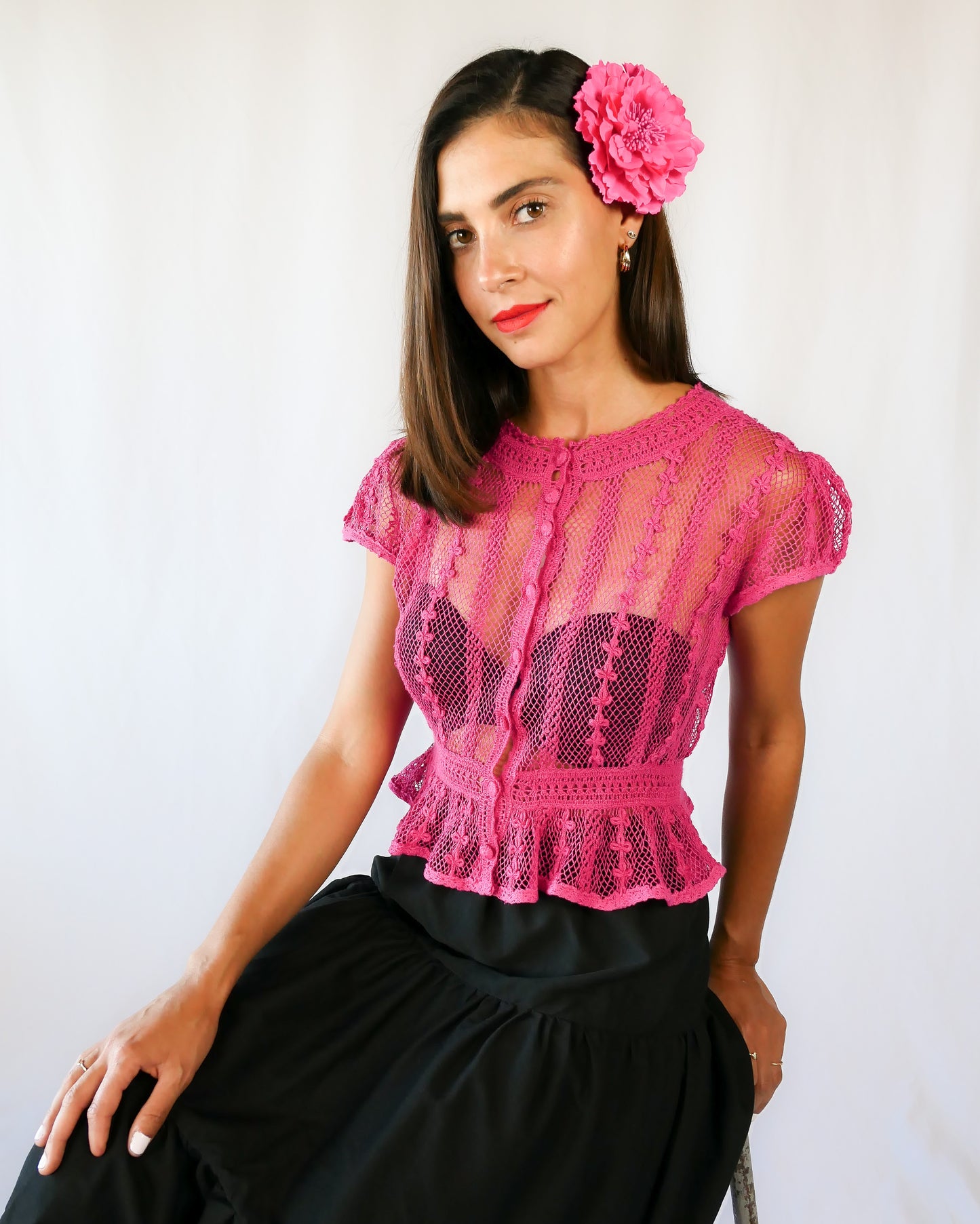 Delicate mesh pattern hand crocheted short puff sleeve top in a pretty fuschia pink!  This top has a high waist and flared hem. This is a Lim’s original vintage piece from the 1980s with trim added recently to finish the hem.  The top is reversible and can be buttoned up the front or back.  