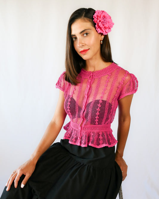 Delicate mesh pattern hand crocheted short puff sleeve top in a pretty fuschia pink!  This top has a high waist and flared hem. This is a Lim’s original vintage piece from the 1980s with trim added recently to finish the hem.  The top is reversible and can be buttoned up the front or back.  