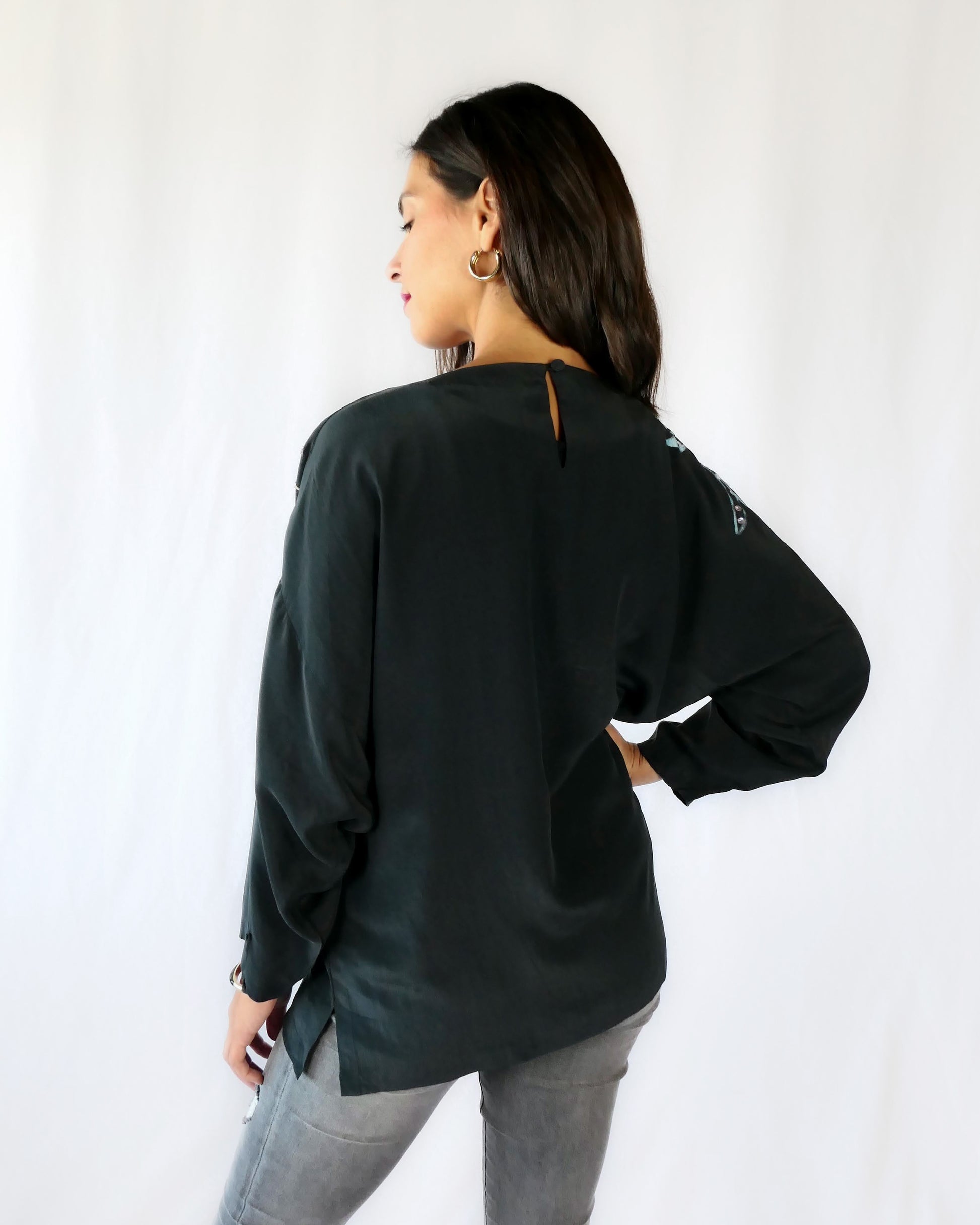 Back view.  The black silk top has one button at the back.