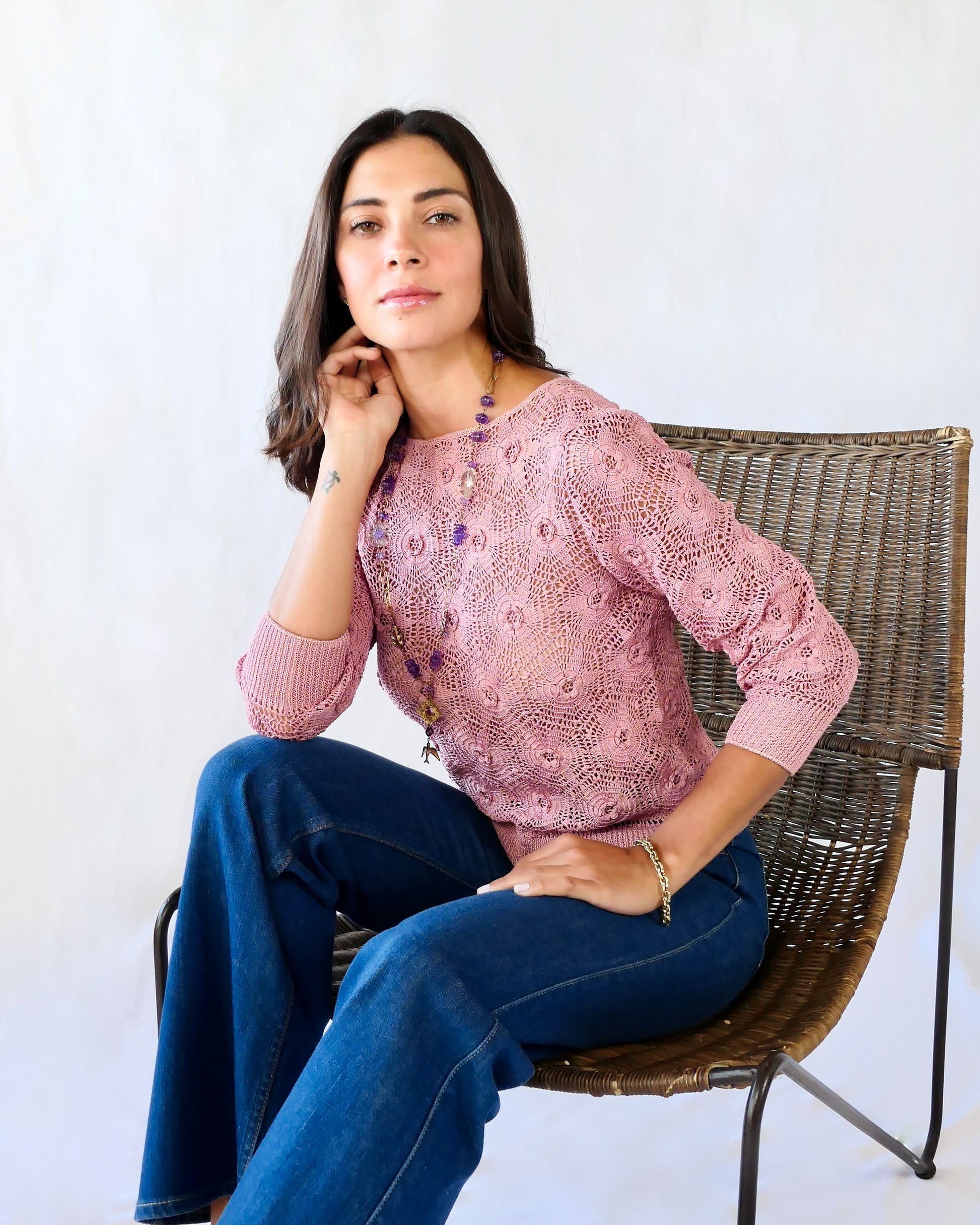 Your everyday fitted sweater with a twist. Hand crocheted crewneck sweater in a soft muted rose color, with star shaped flowers and elastic banding at the hip and wrists.  Our model is 5'4" and wears a size Small. 