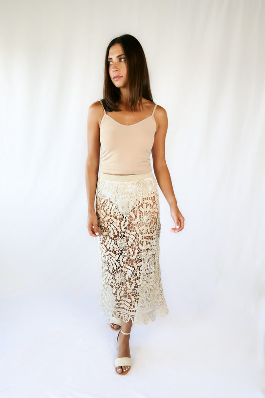 This boho chic, elegant Lim’s hand crocheted pencil skirt makes a great beach coverup for your next resort getaway.  Floral and leaf motif throughout, with a zigzag embellished hem and comfortable fitting elastic waistband.  This piece is an original Lim’s skirt from the 1980s, with the elastic replaced at the waistband and in excellent condition.  Size: Fits XS to Small  Measurements:  Waist 26”-28” Length 34” Hip 36”-38” Color: Natural  Material: 100% cotton