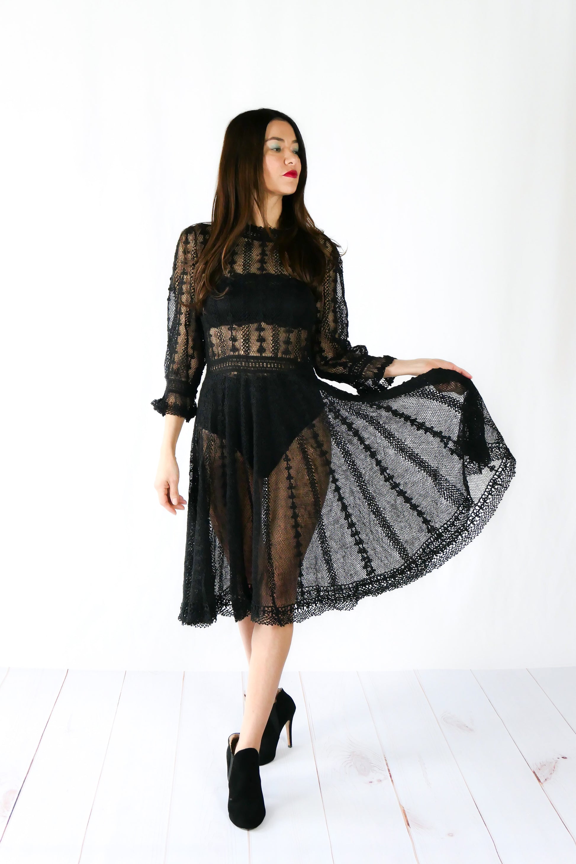 A beguiling black version of our cottage core style midi length crochet dress, this dreamy Lim's original vintage piece from the 1980s is made with very fine threads, creating a refined and sheer look. Detailed crochet trim is used at the waist, hemline, and 3/4 length ruffled sleeves. Measurements:  Bust 36” Waist 30” Length 42” Shoulder width 15” Sleeve 20” Cuff circumference 9" Color: Black
