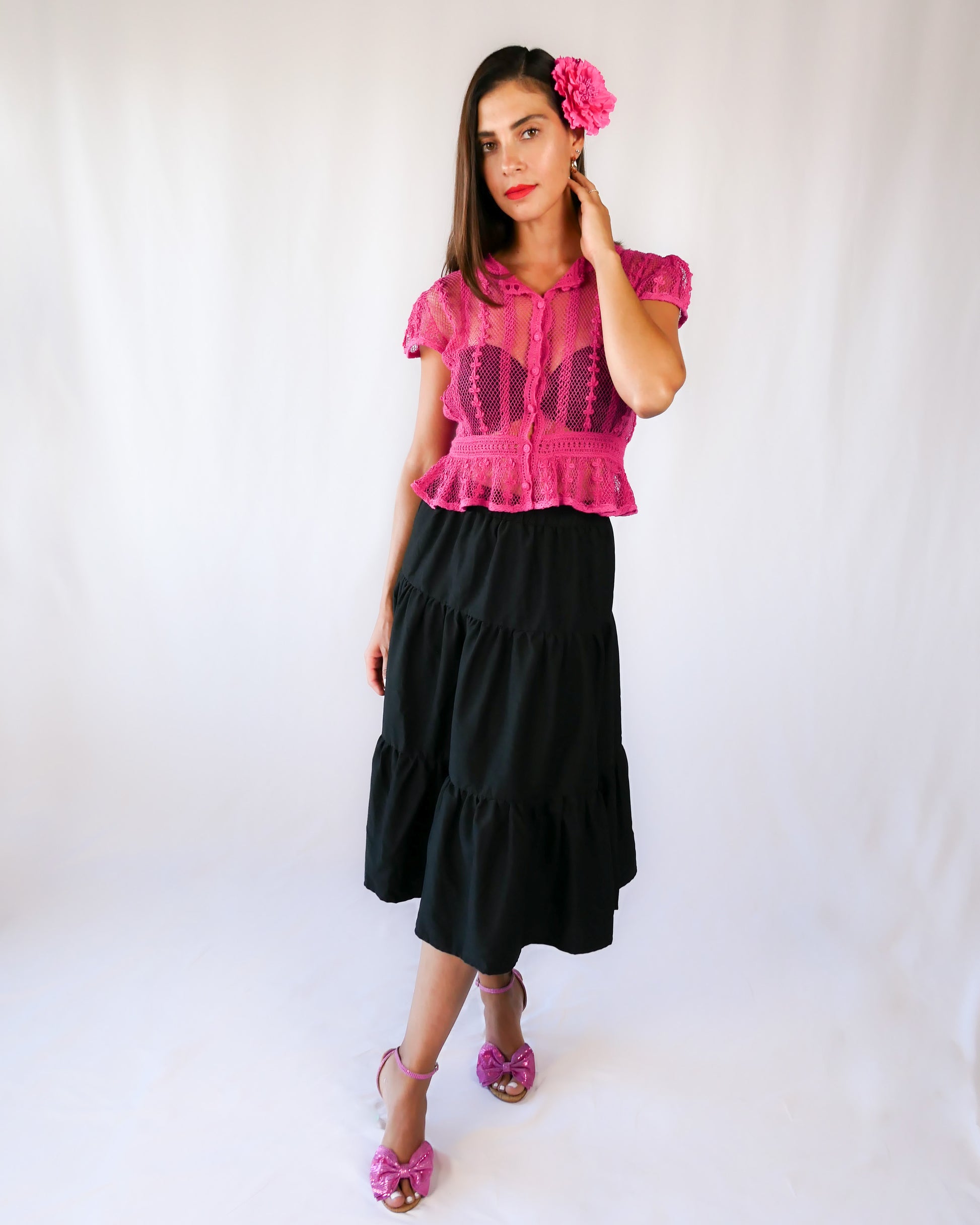 Delicate mesh pattern hand crocheted short puff sleeve top in a pretty fuschia pink!  This top has a high waist and flared hem. This is a Lim’s original vintage piece from the 1980s with trim added recently to finish the hem.  The top is reversible and can be buttoned up the front or back.  
