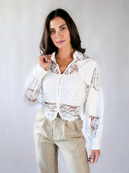 An almost-cropped, lightweight shirt using our vintage Lim's crochet and embroidered cotton fabric, with puff sleeves for a romantic twist. Pair it with high-waisted jeans for casual days, or try it with a flowing midi skirt or wide-legged trousers to dress it up.