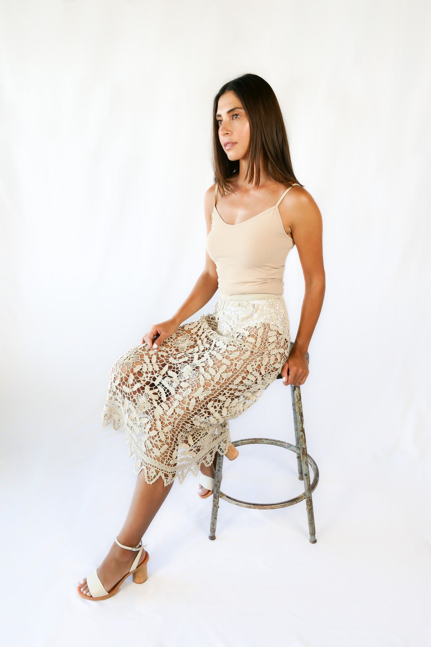 This boho chic, elegant Lim’s hand crocheted pencil skirt makes a great beach coverup for your next resort getaway.  Floral and leaf motif throughout, with a zigzag embellished hem and comfortable fitting elastic waistband.  This piece is an original Lim’s skirt from the 1980s, with the elastic replaced at the waistband and in excellent condition.  Size: Fits XS to Small  Measurements:  Waist 26”-28” Length 34” Hip 36”-38” Color: Natural  Material: 100% cotton