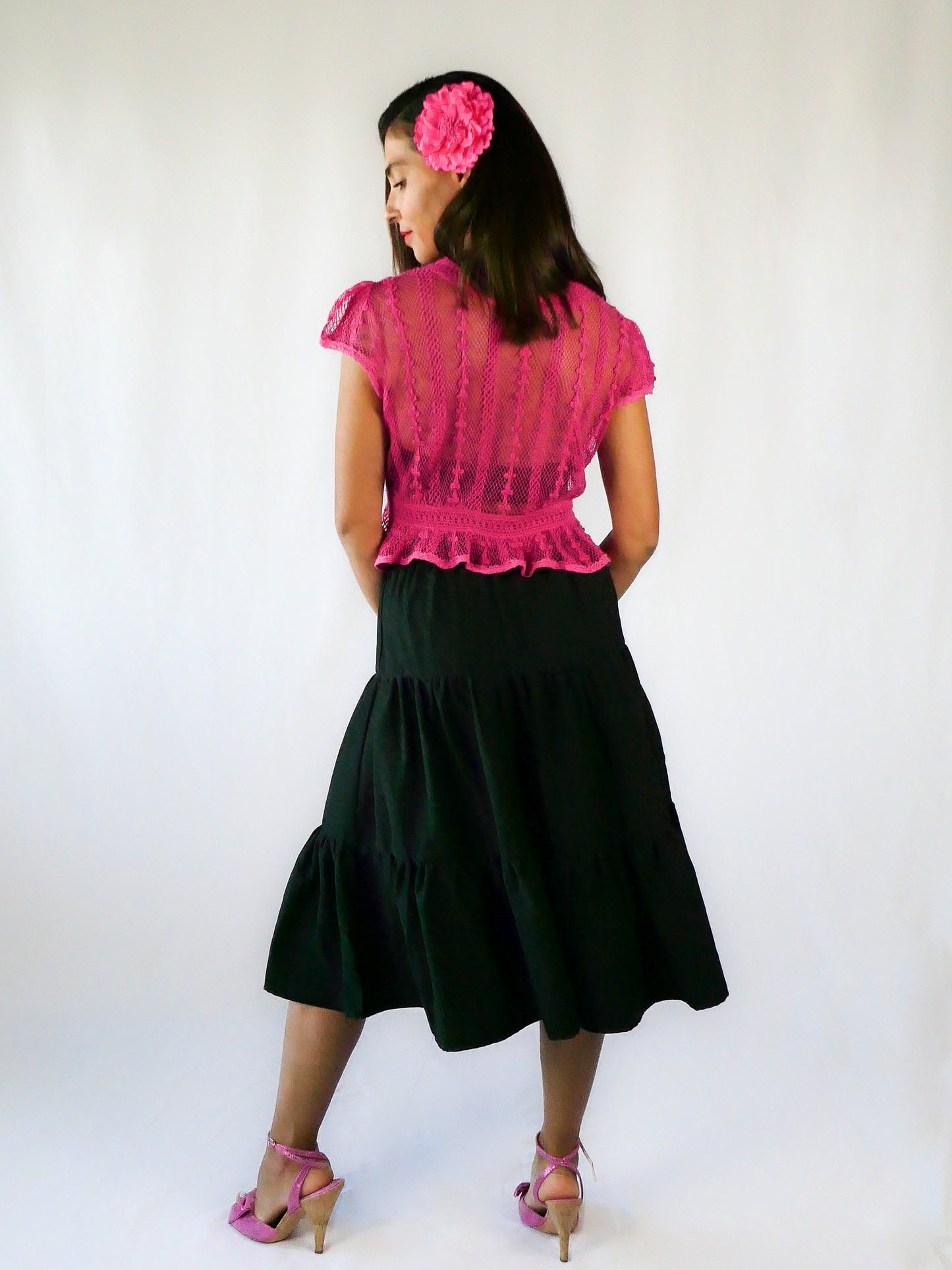 Delicate mesh pattern hand crocheted short puff sleeve top in a pretty fuschia pink!  This top has a high waist and flared hem. This is a Lim’s original vintage piece from the 1980s with trim added recently to finish the hem.  The top is reversible and can be buttoned up the front or back.  